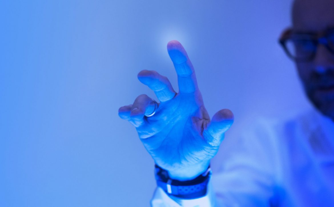 Man touching the futuristic blue screen